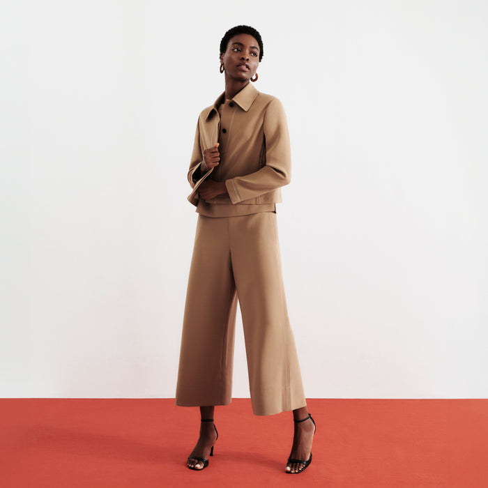 front image of a woman wearing the nicky jacket in saddle