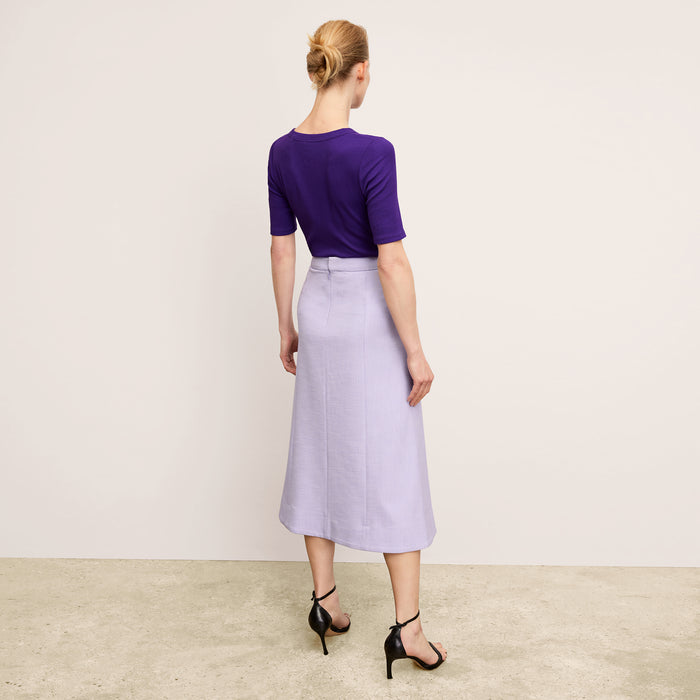 back image of a woman wearing the eva skirt in lilac/ivory