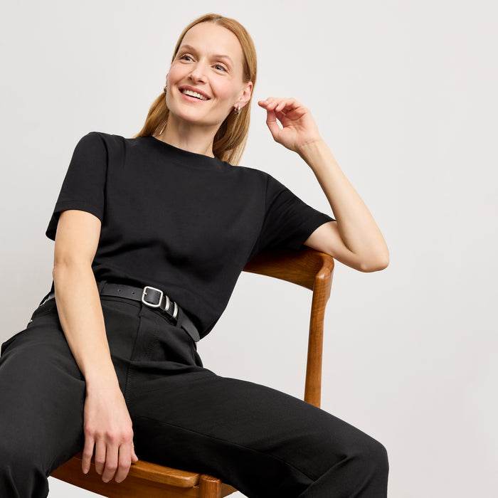 Front image of a woman in the daria pant in black