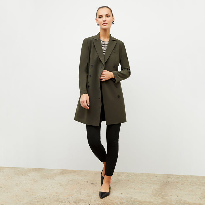 Front image of a woman wearing the gwynne dress in olive
