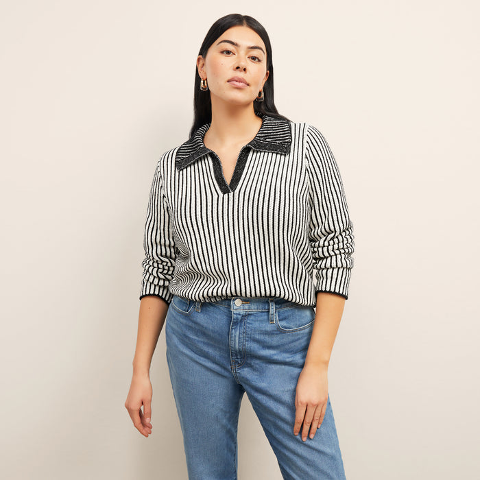 front image of a woman wearing the maja sweater in black/ivory