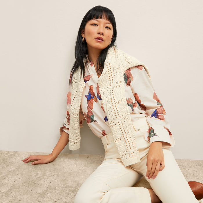 front image of a woman wearing the mila top in hummingbird print