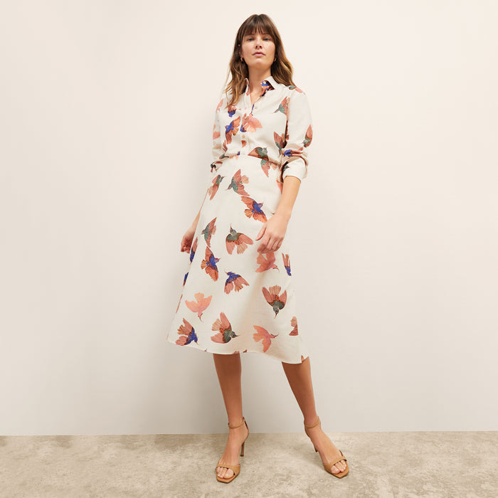 front image of a woman wearing the mila top in hummingbird print