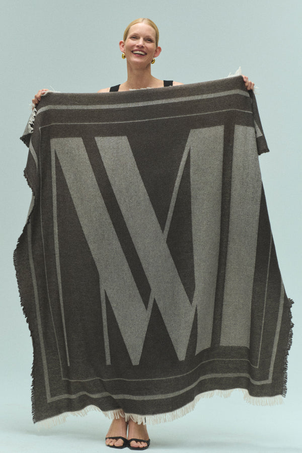 front image of a woman holding the GWP Blanket | Exclude | Grid