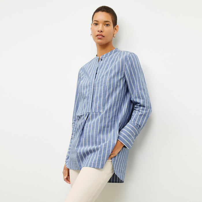 front image of a woman wearing the Nichols shirt in blue and white poplin stripe | Lead